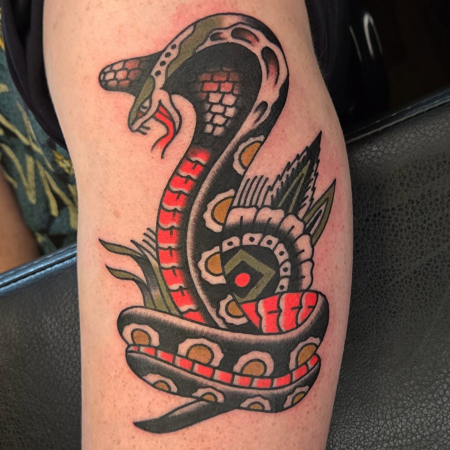 Snake American traditional tattoo on the thigh by Deke Harms, Bend, Oregon