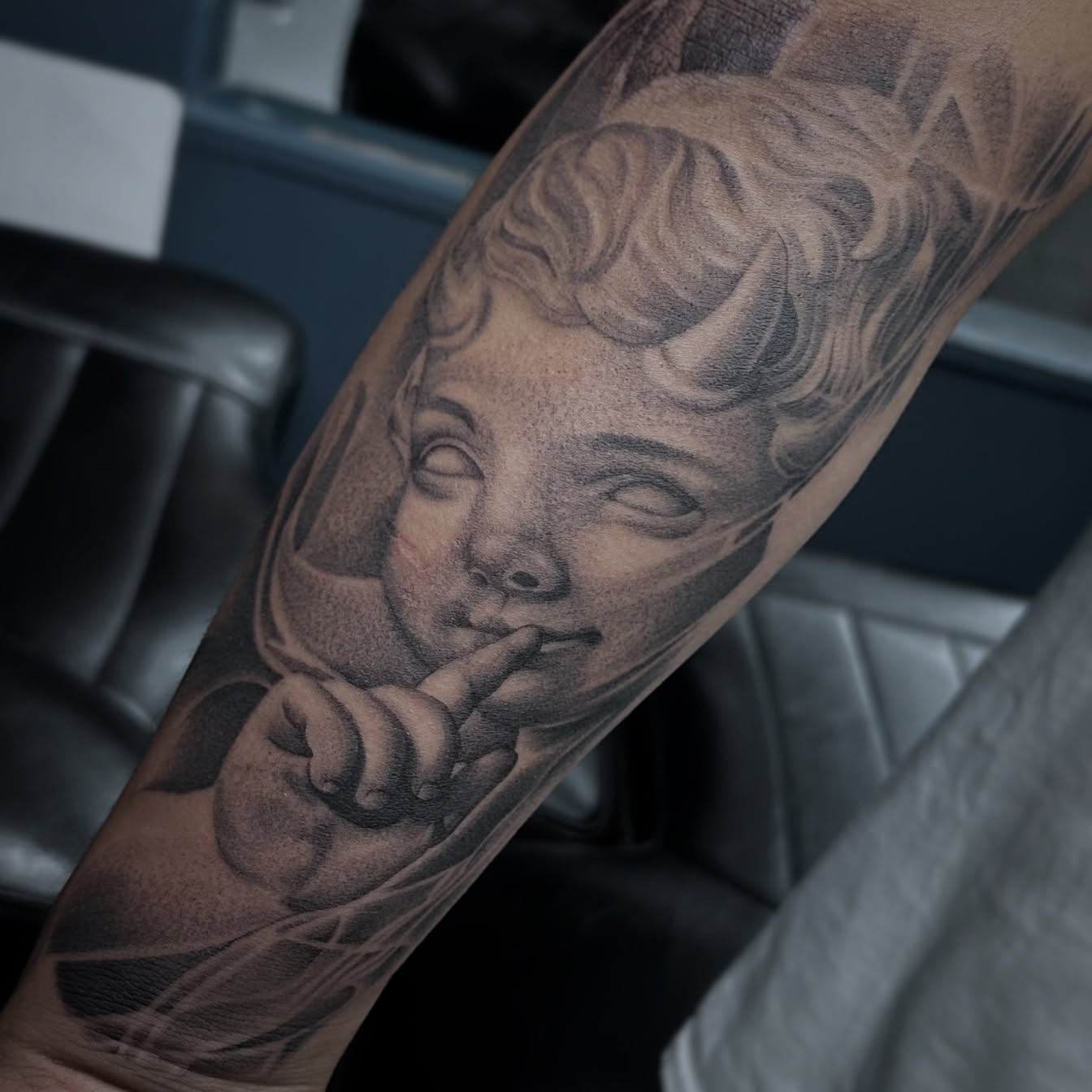 Child's face realism tattoo on the forearm by Rachel Martinez