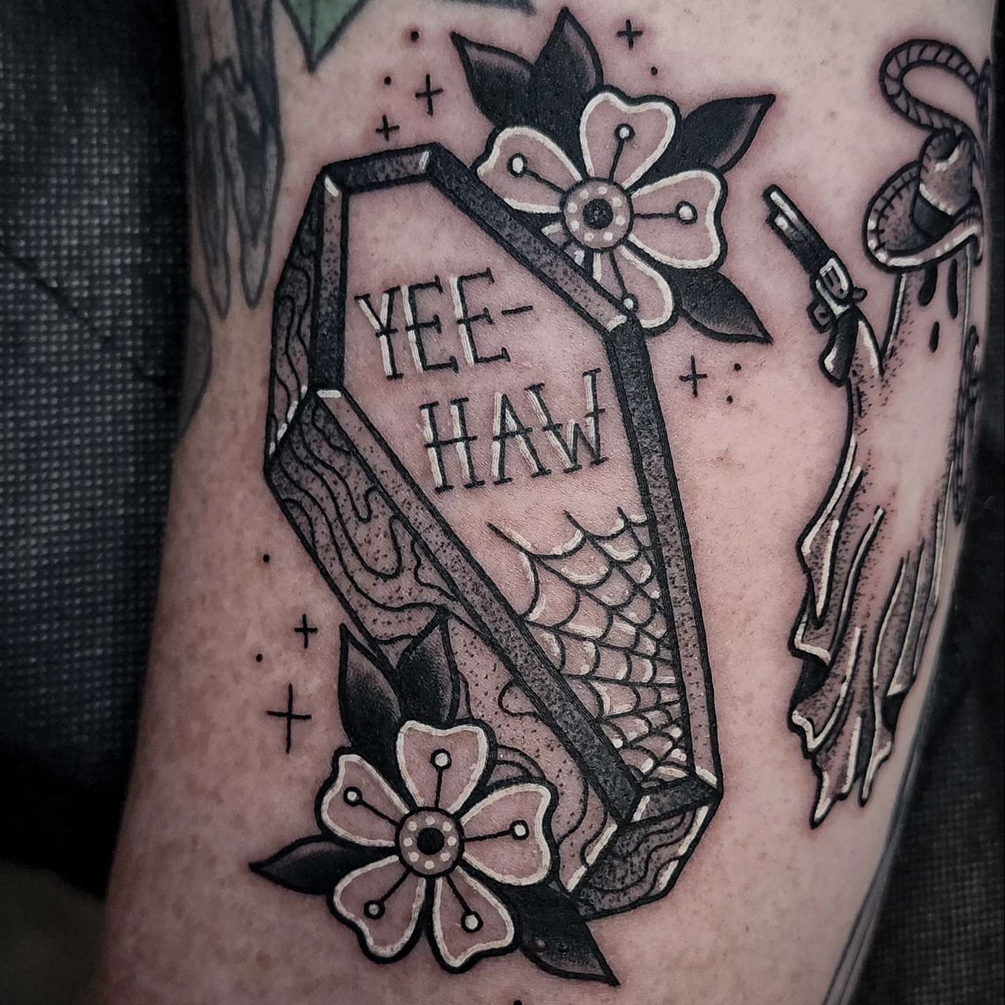 Coffin with 'YEE-HAW' American traditional tattoo on the forearm by Mariah Giovanna Hodgens