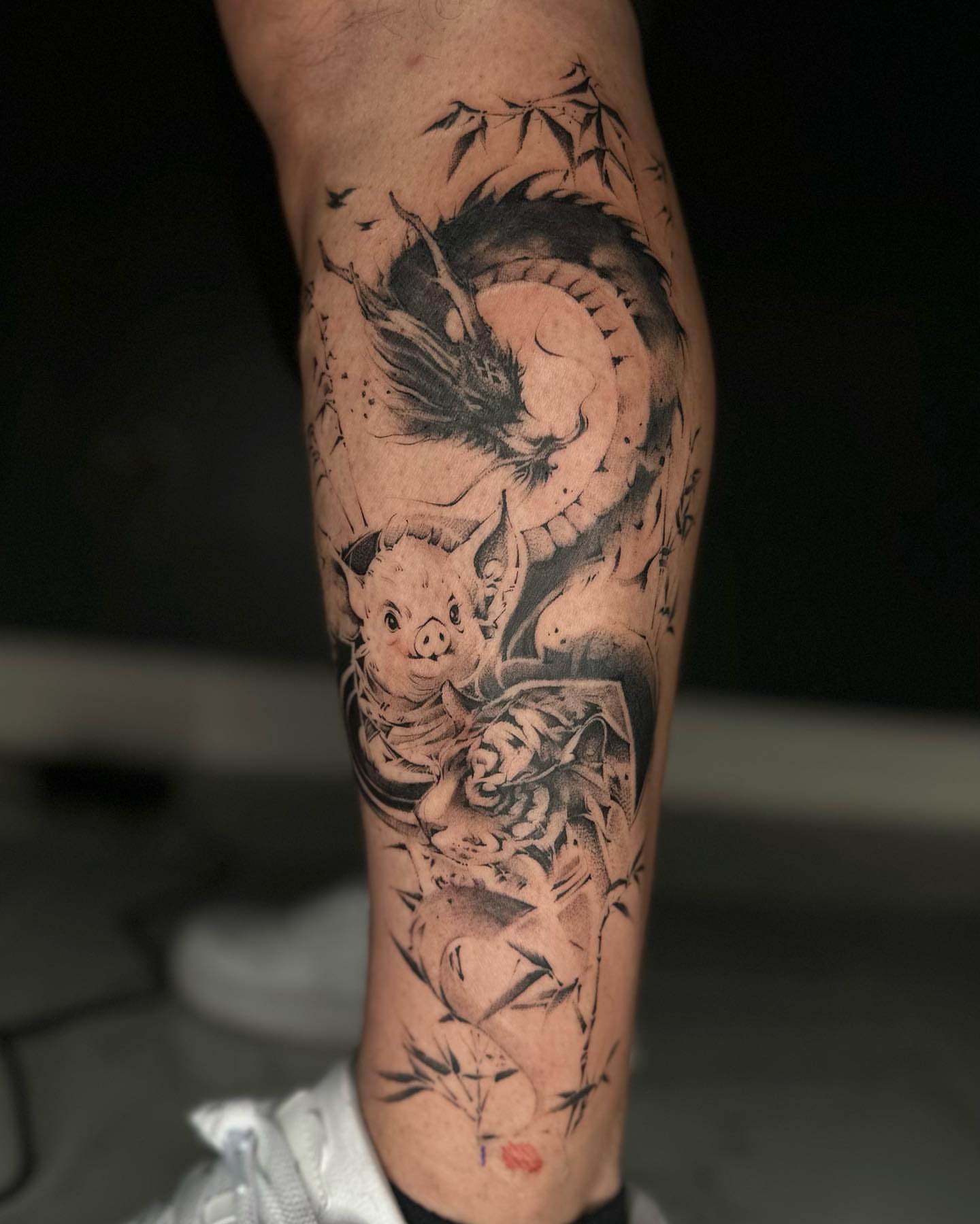 Pig and dragon realism tattoo on the forearm by Shihao zhao