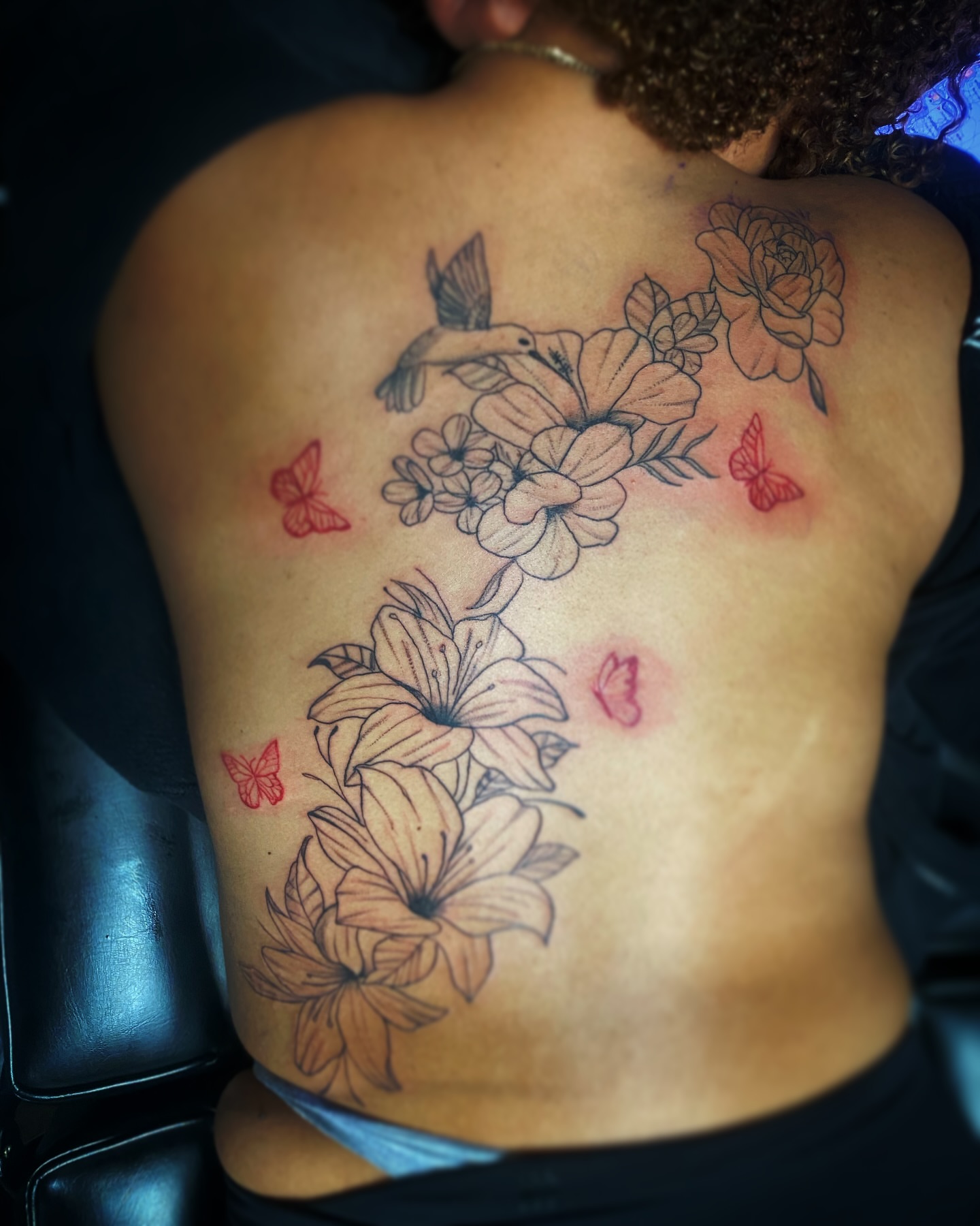 Floral bouquet black and grey tattoo on the back by Rico Rosario