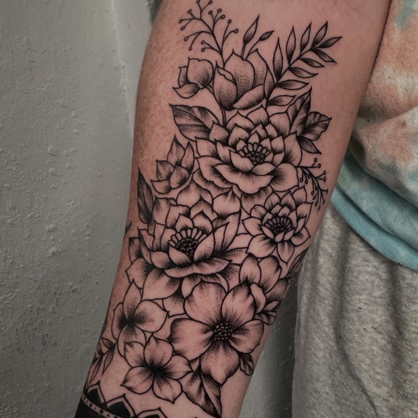 Floral bouquet black and grey tattoo on the forearm by Lisa Nikolopoulos, New York, New York