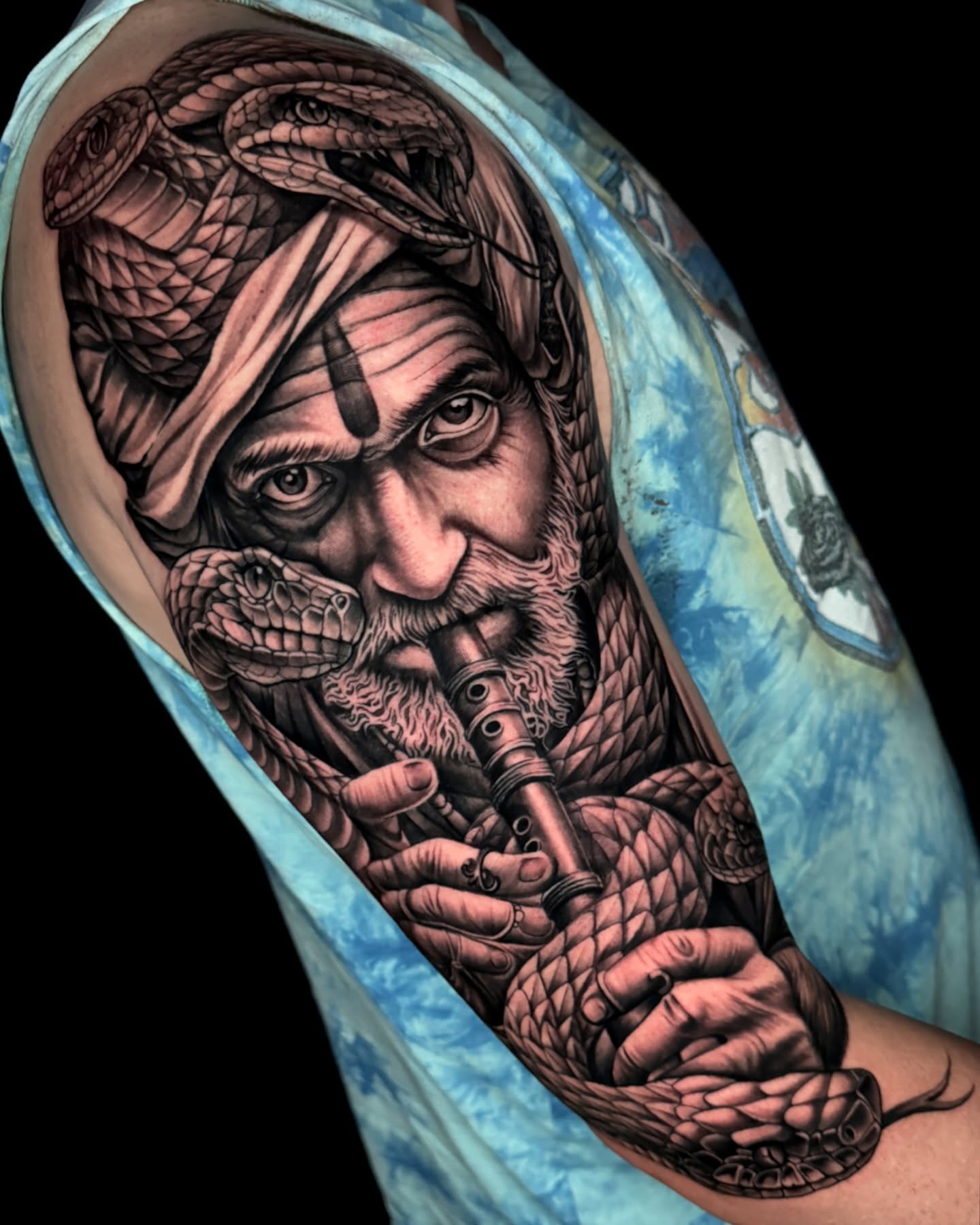 Man playing flute realism tattoo on the forearm by James Boag
