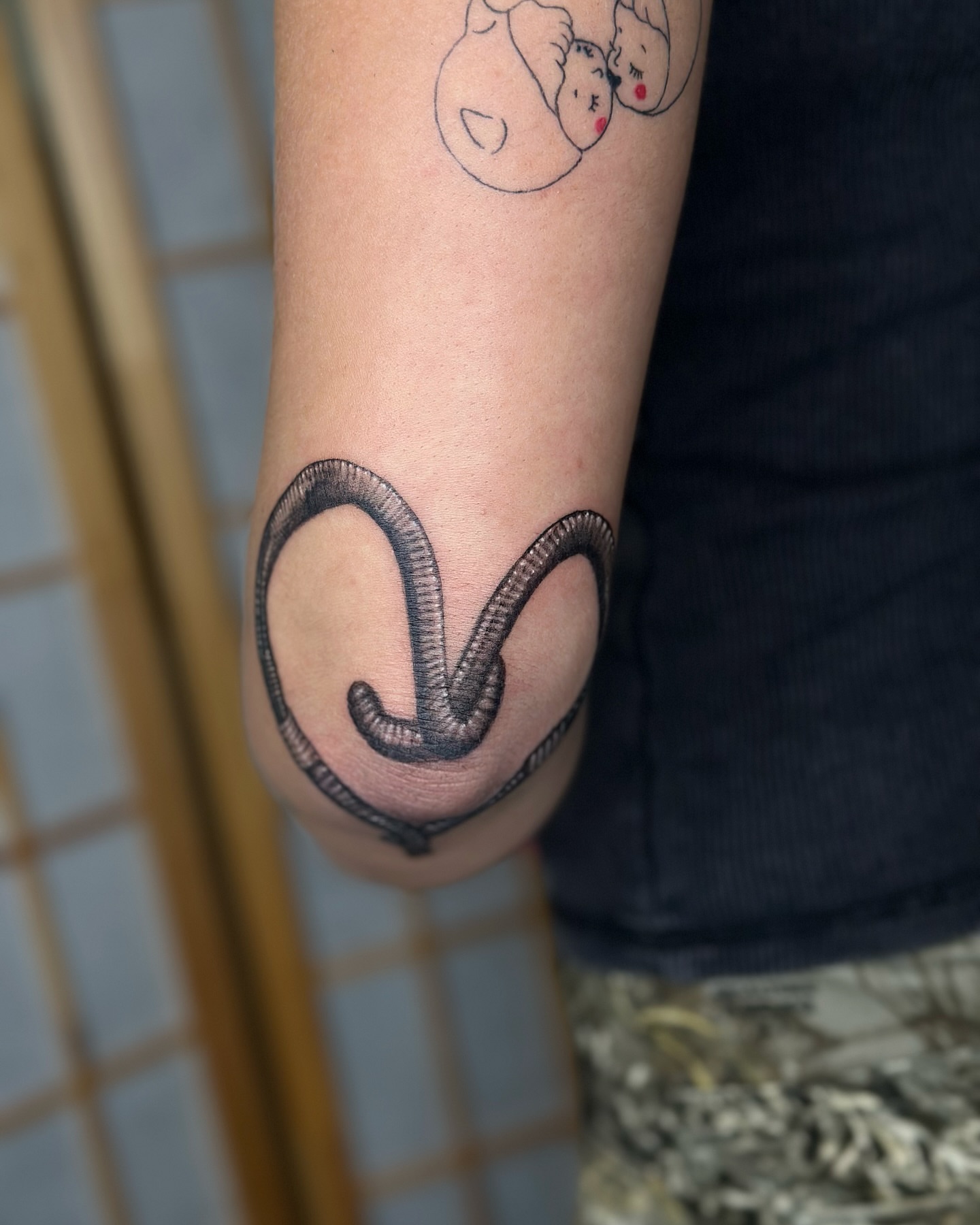 Snake black and grey tattoo on the forearm by cora cupid