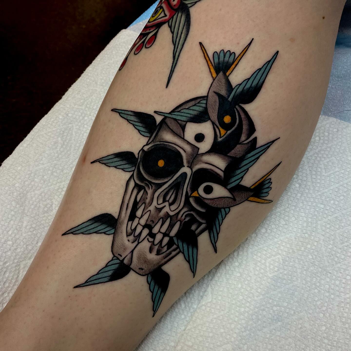 Skull with birds American traditional tattoo on the forearm by Justin R. Mitchell, Fort Worth, Texas