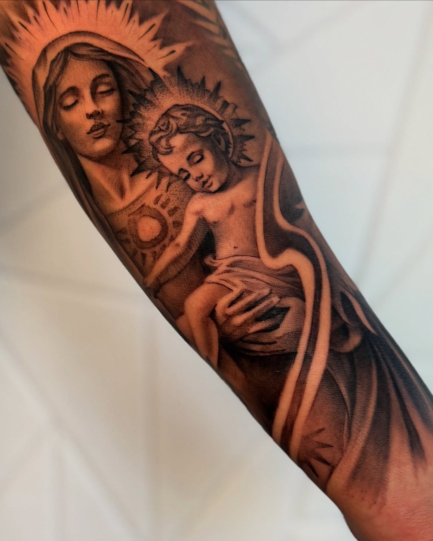 Religious iconography realism tattoo on the forearm by Isiah Hall, Whittier, California