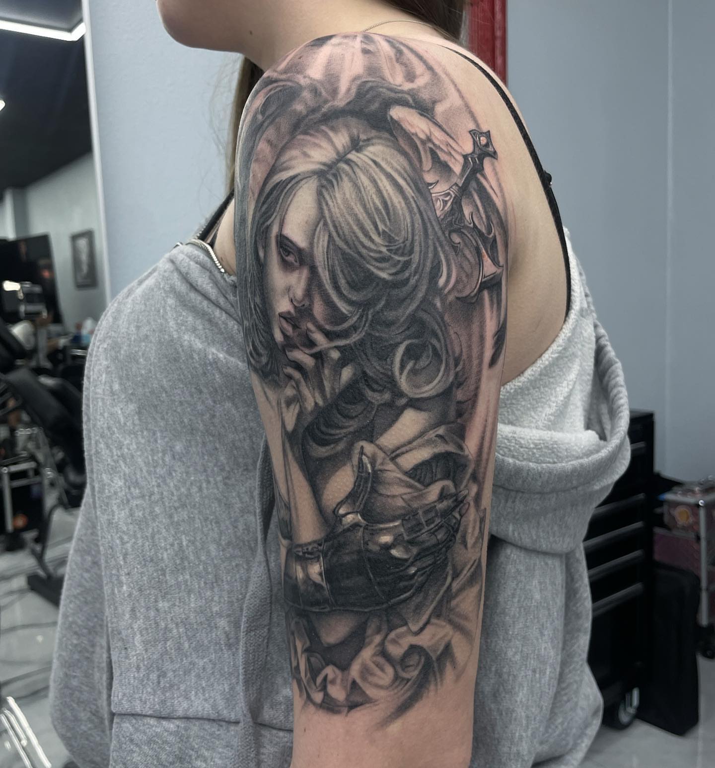 Female warrior realism tattoo on the upper arm by Austin Jones