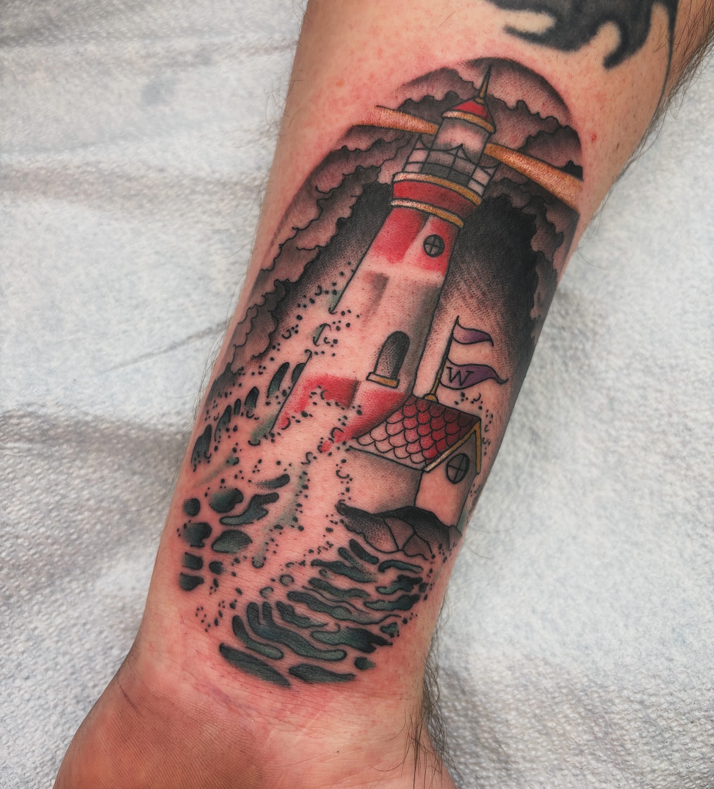 Lighthouse American traditional tattoo on the forearm by Adam Bailey, Portland, Oregon