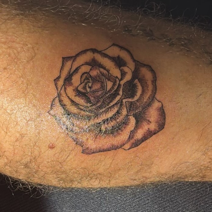 Rose black and grey tattoo on the forearm by sams tattoos
