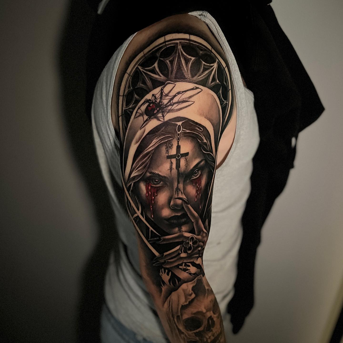 Woman with cross dark realism tattoo on the forearm by Miles Johnson
