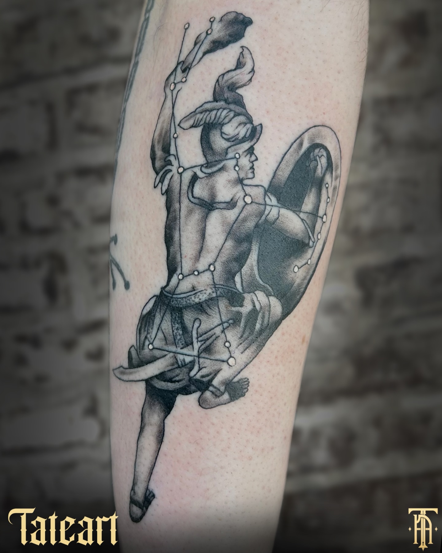 Mythical warrior black and grey tattoo on the forearm by Tate Wortham