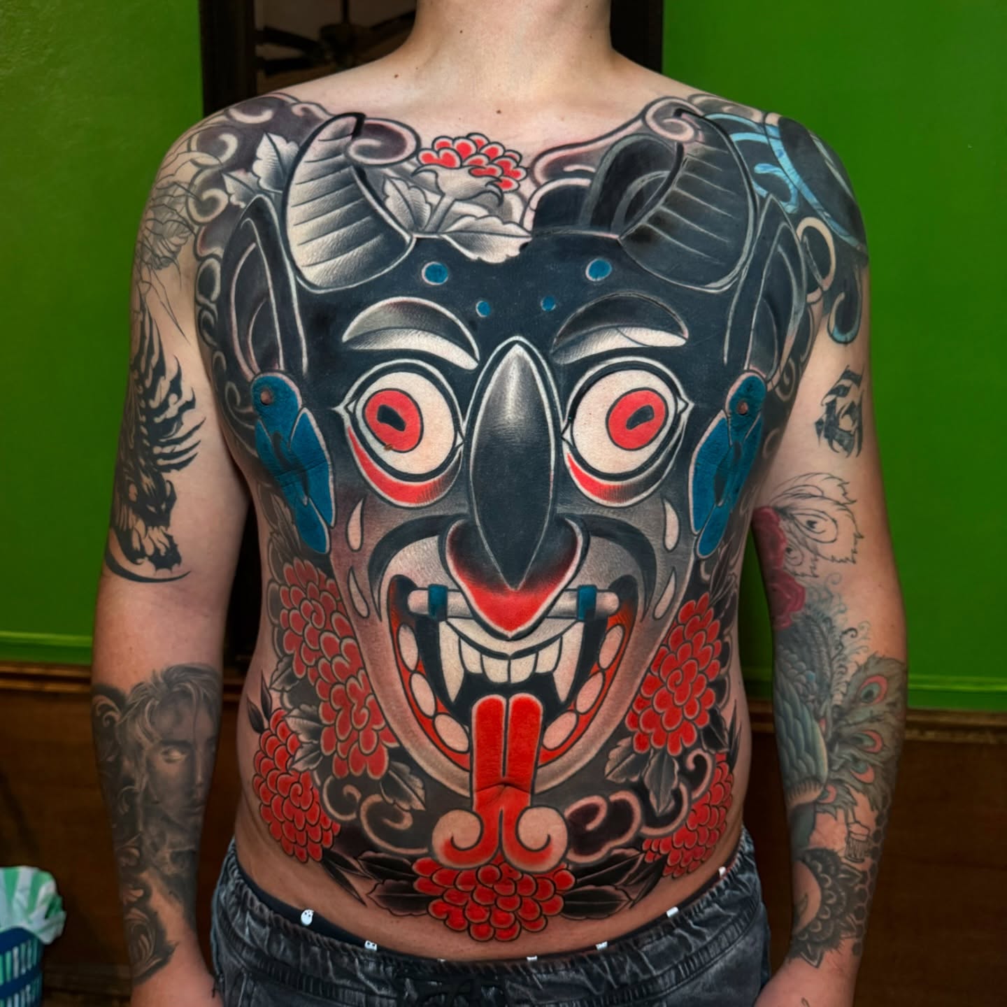 Demon mask japanese irezumi tattoo on the chest by Meza Cruz