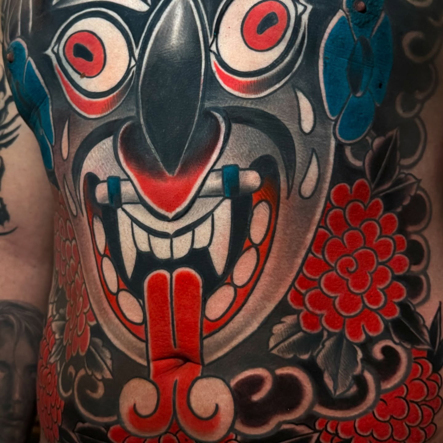 Japanese mask japanese irezumi tattoo on the chest by Meza Cruz