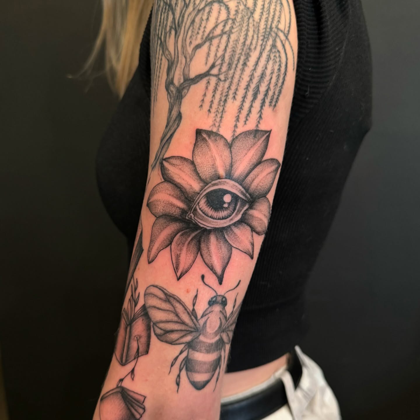 Flower with eye dotwork tattoo on the forearm by Jay Kreidler