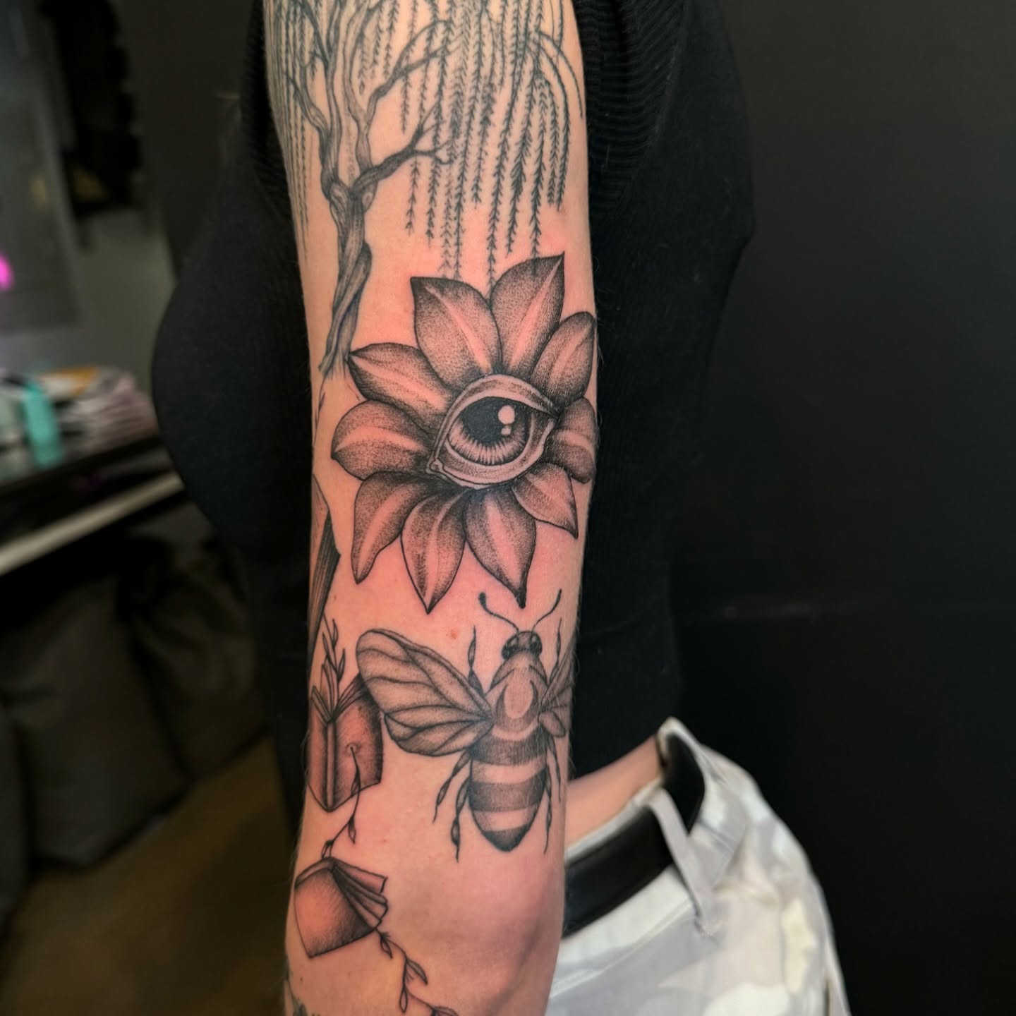 Flower with eye dotwork tattoo on the forearm by Jay Kreidler
