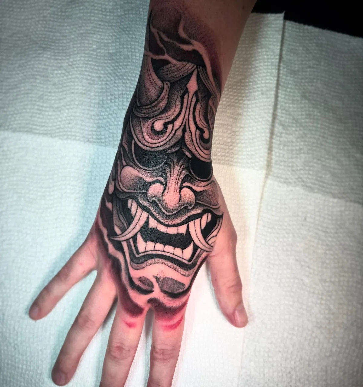 Demon mask japanese irezumi tattoo on the hand by David Mushaney