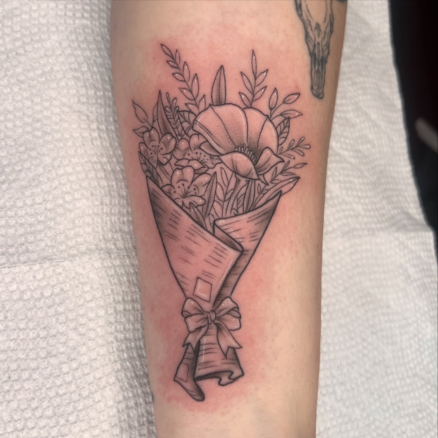 Flower bouquet black and grey tattoo on the forearm by Tattoo & Body Artist, Gastonia, North Carolina