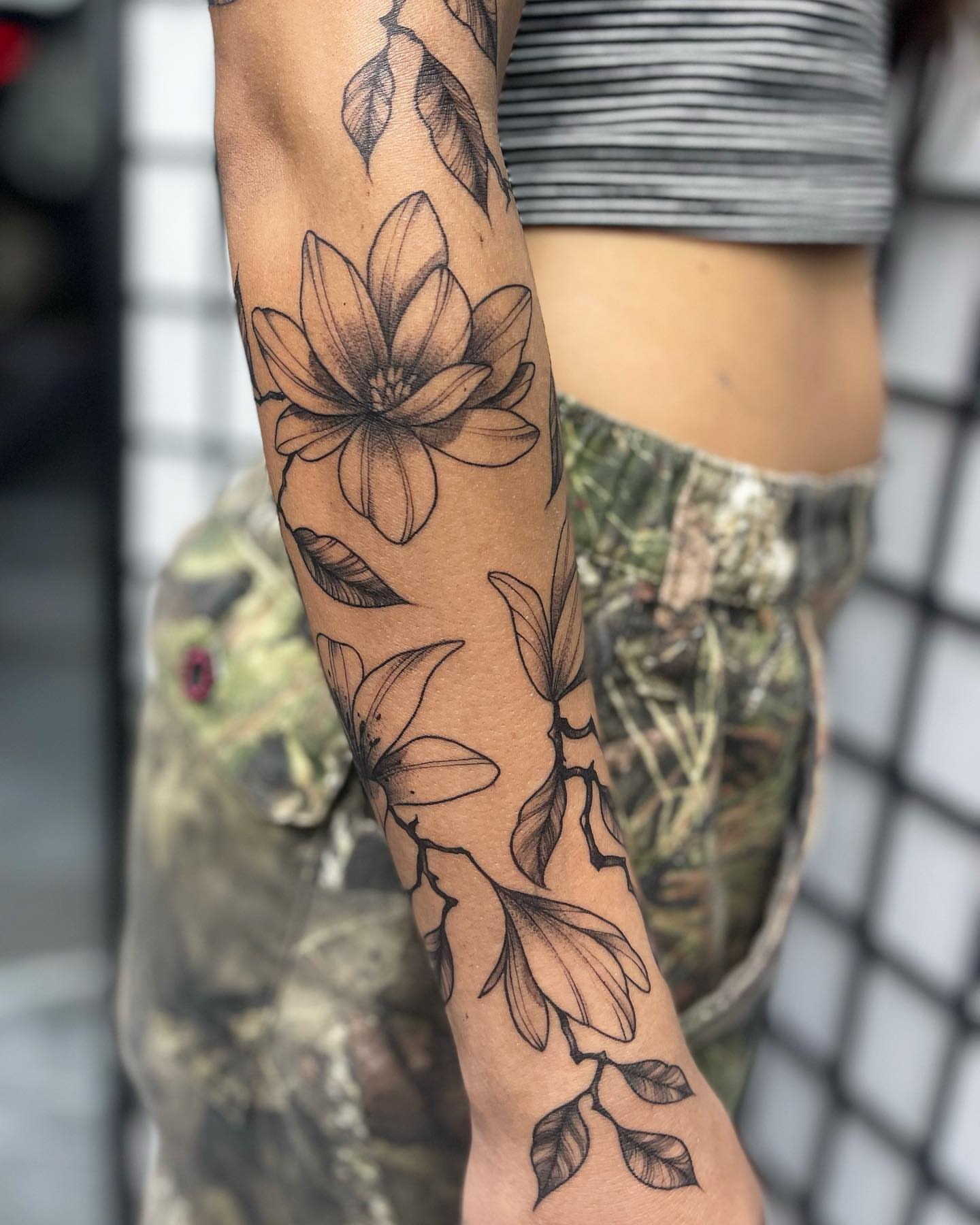 Lotus flower black and grey tattoo on the forearm by Tattoos by Tessa