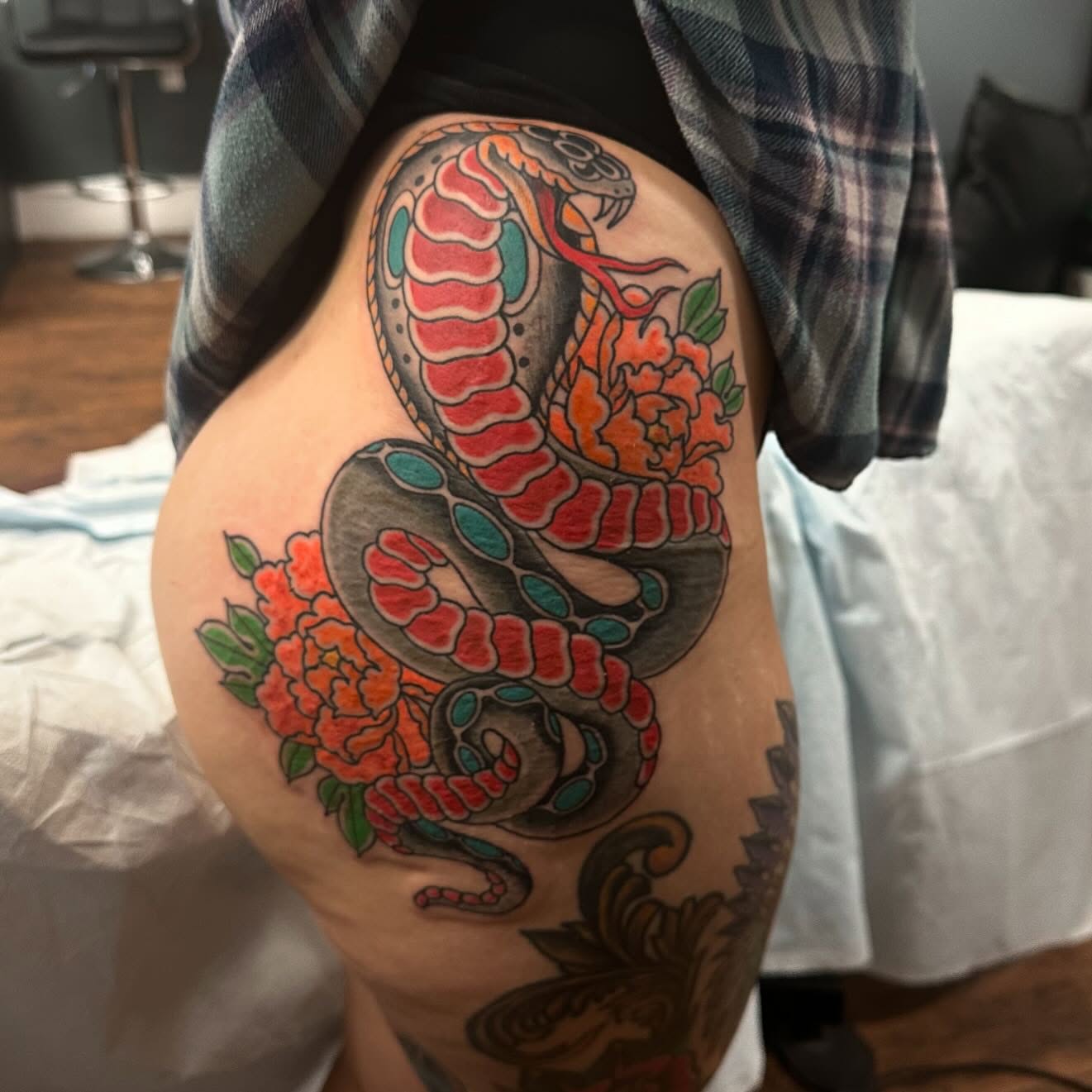 Snake and peony American traditional tattoo on the thigh by Jackie