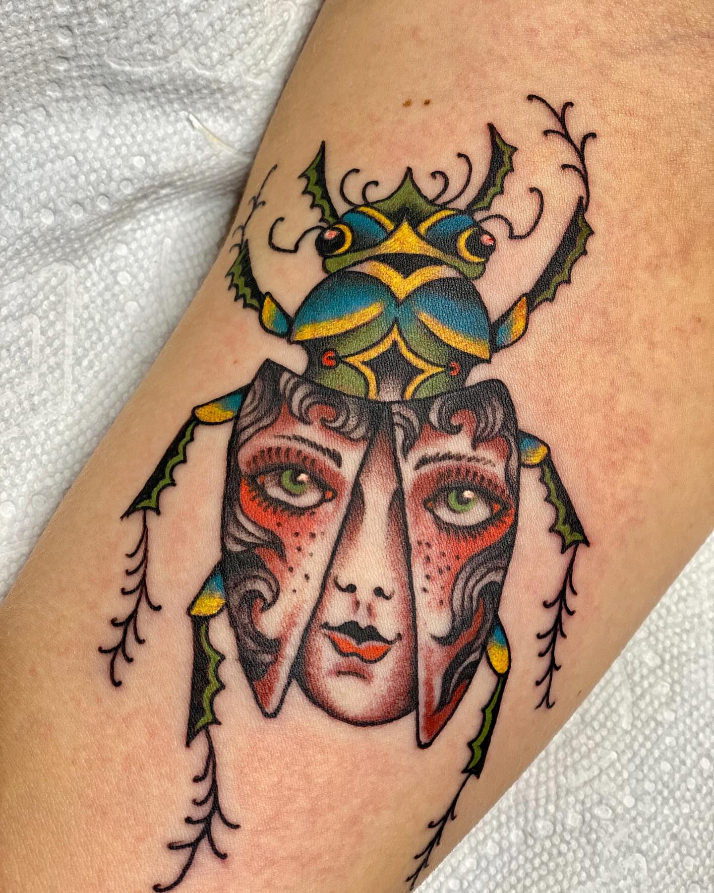 Scarab beetle American traditional tattoo on the forearm by Nick Rodin
