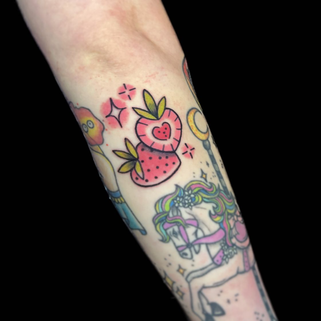 Strawberry and unicorn new school tattoo on the forearm by 🖤Sabrina Ryan🖤