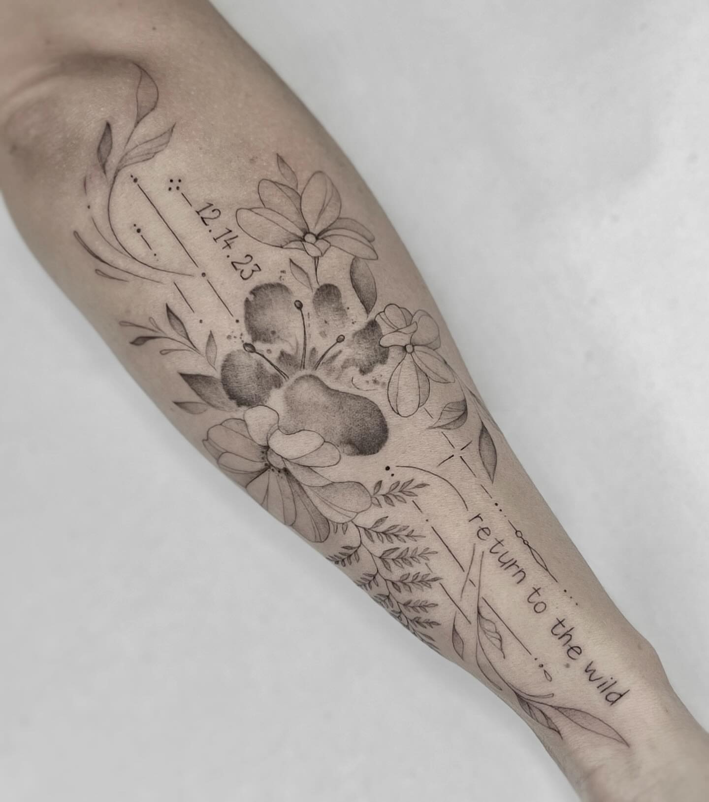 Floral arrangement black and grey tattoo on the forearm by Jax Citriglia