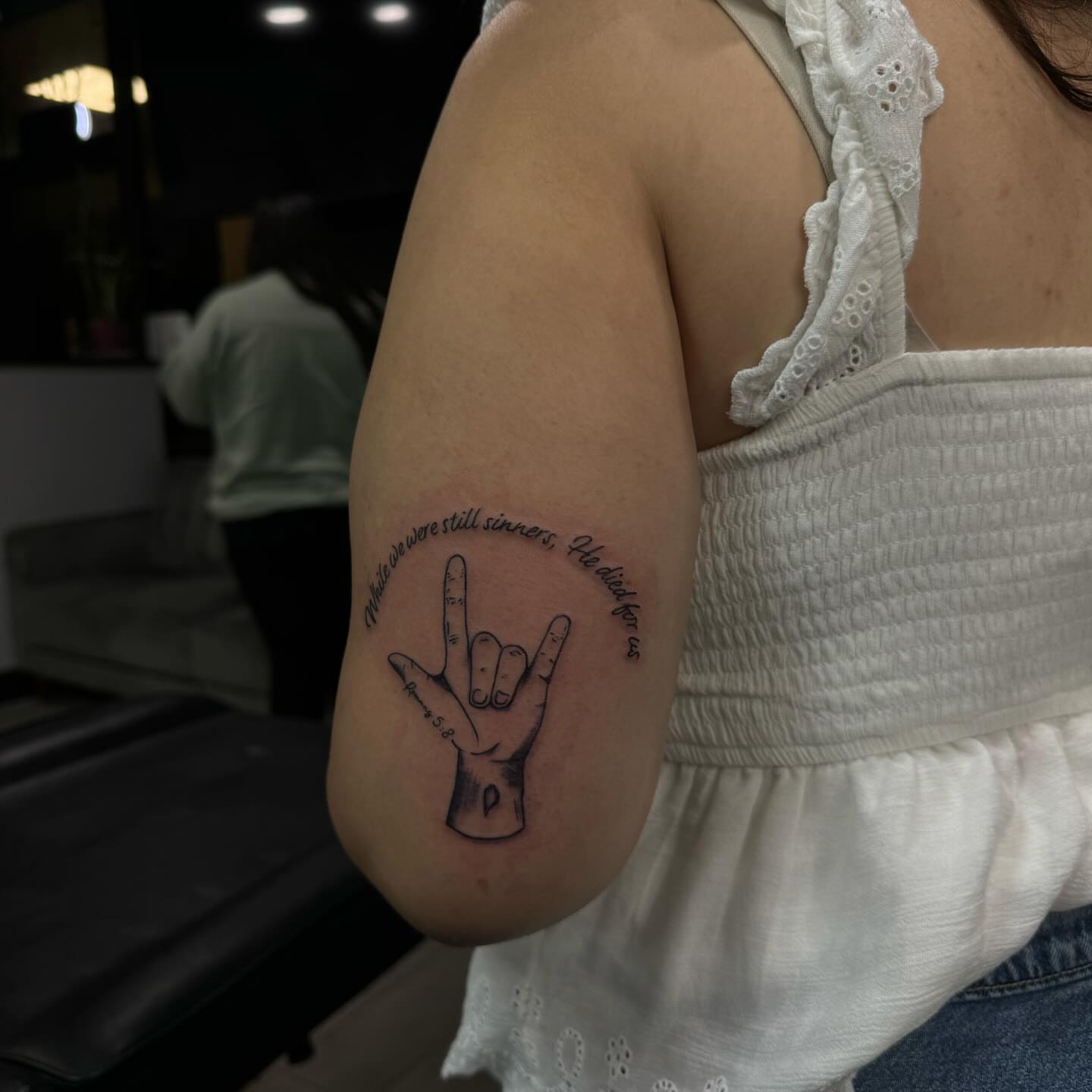 Sign language hand black and grey tattoo on the forearm by Alexa Camacho