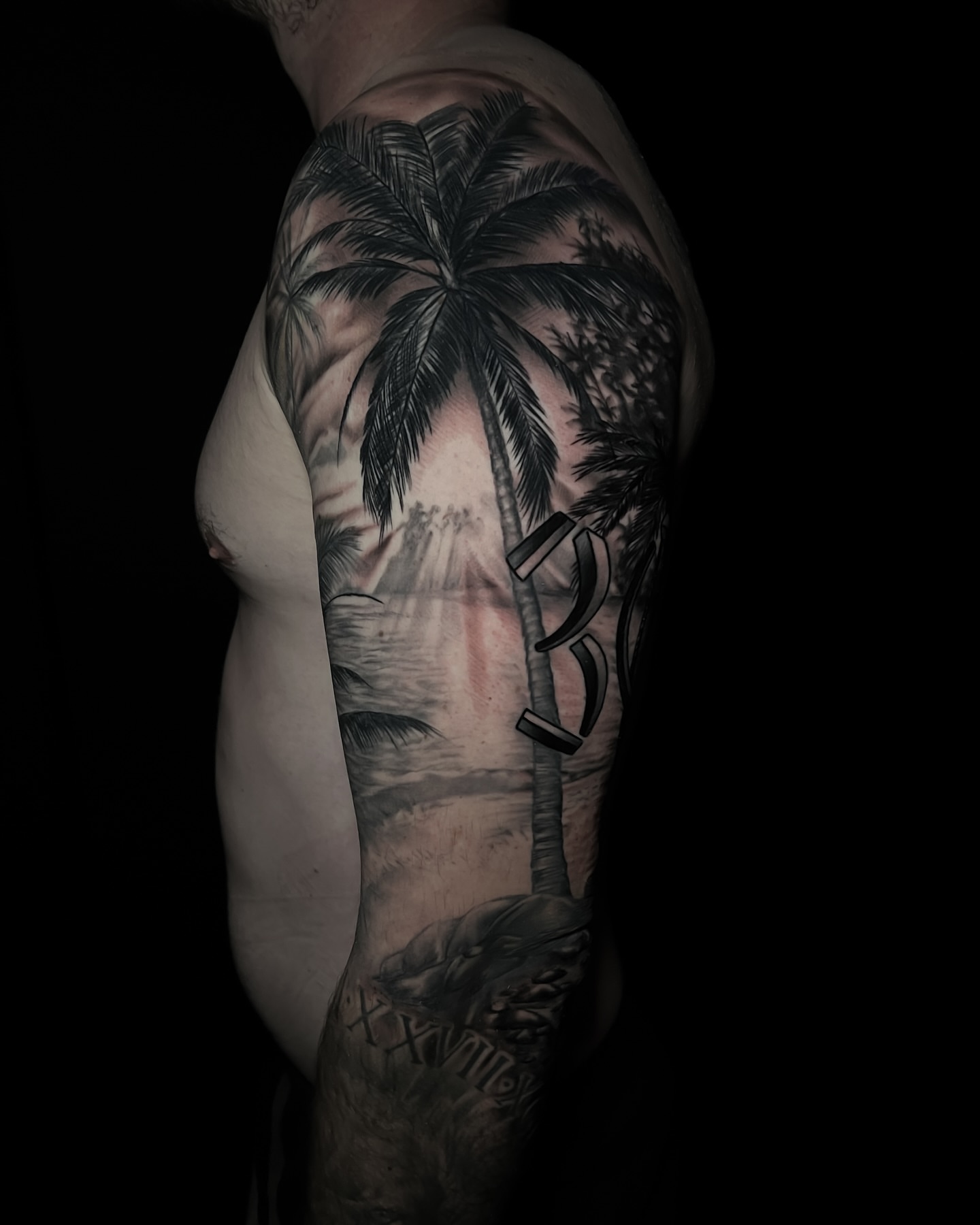 Palm tree realism tattoo on the upper arm by Matt Misiak
