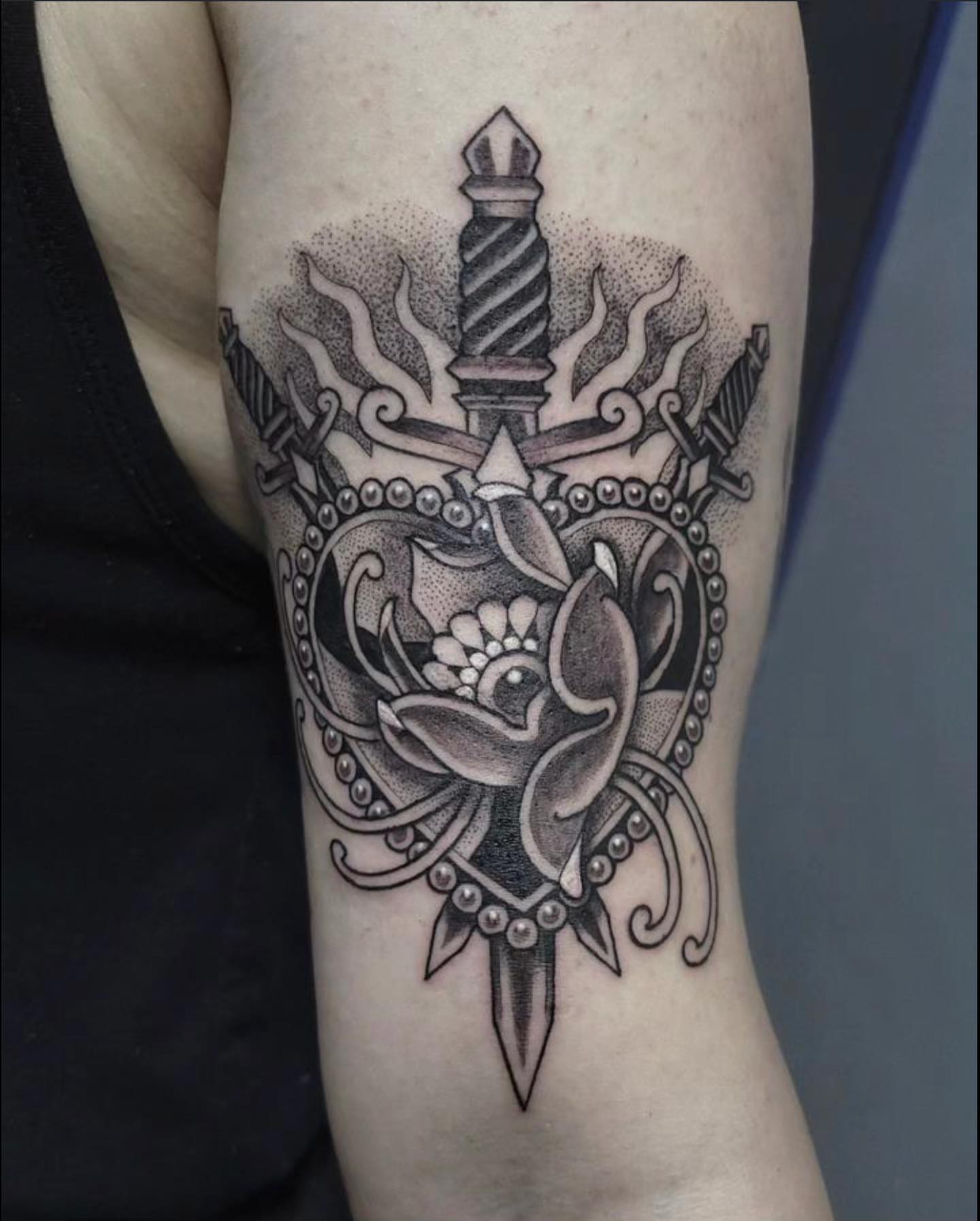 Sword and lotus dotwork tattoo on the forearm by Sean Hollinger