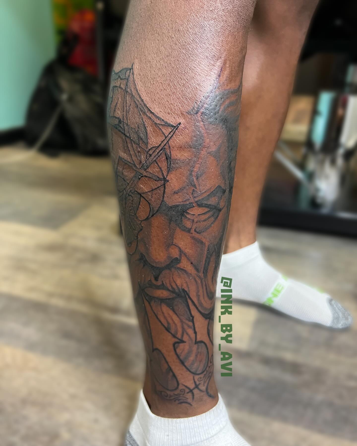 Lion black and grey tattoo on the calf by Avi, Cleveland, Ohio