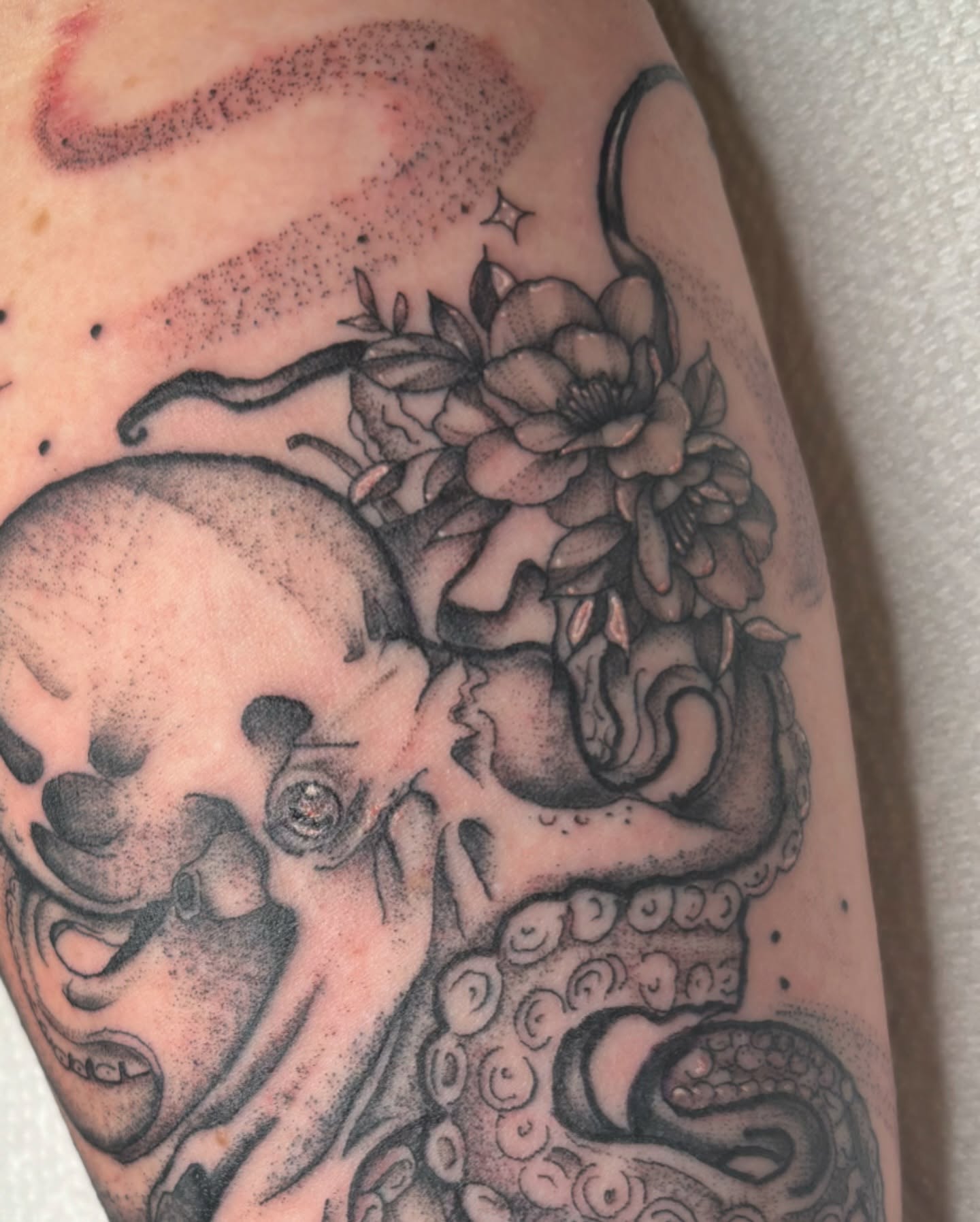 Octopus and flowers dotwork tattoo on the forearm by Bridget Smith