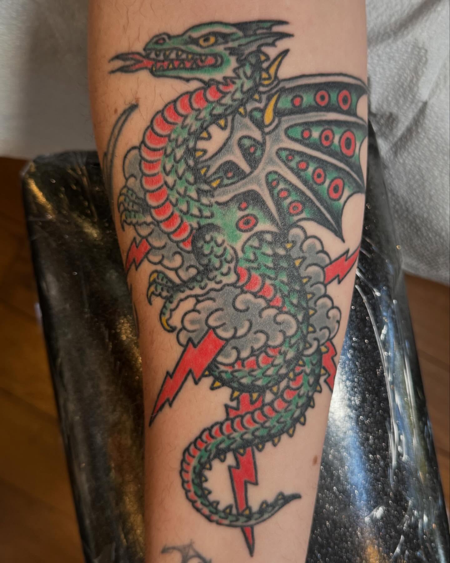 Dragon American traditional tattoo on the forearm by Jesse Swanson, Santa Rosa, California
