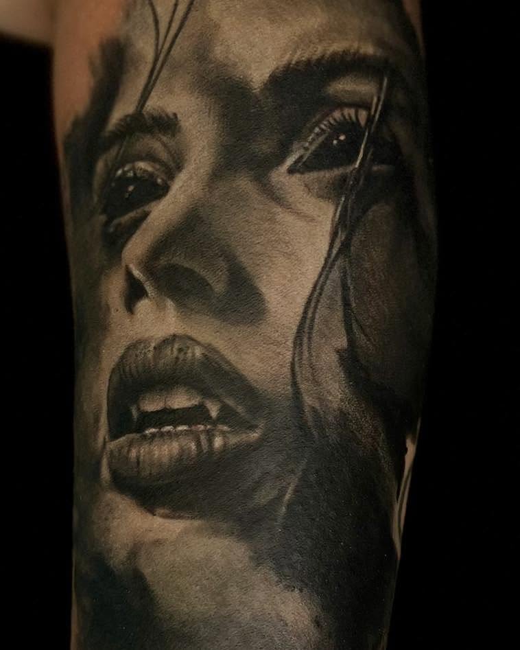 Woman's face realism tattoo on the forearm by James Reed Tattoo artist