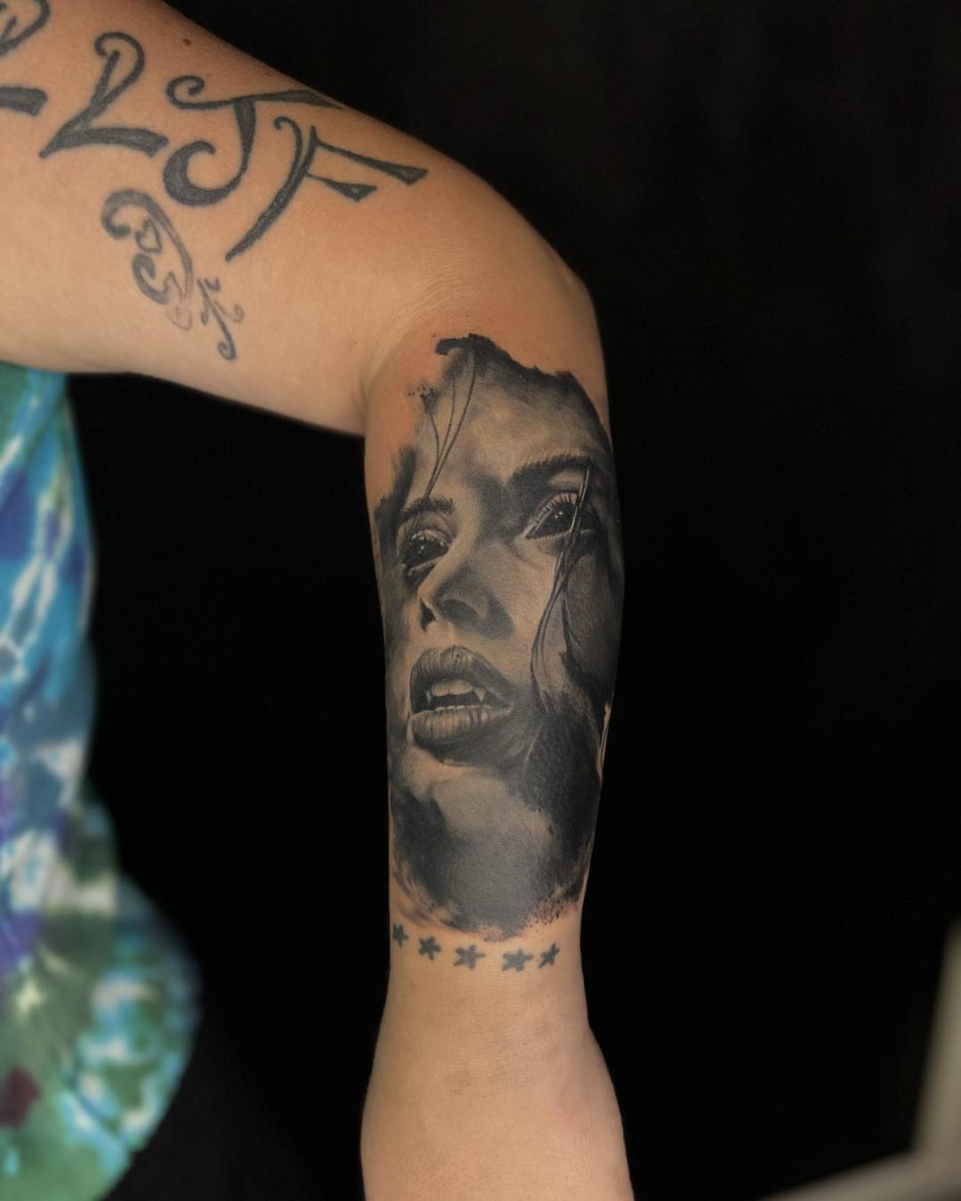 Portrait realism tattoo on the forearm by James Reed Tattoo artist