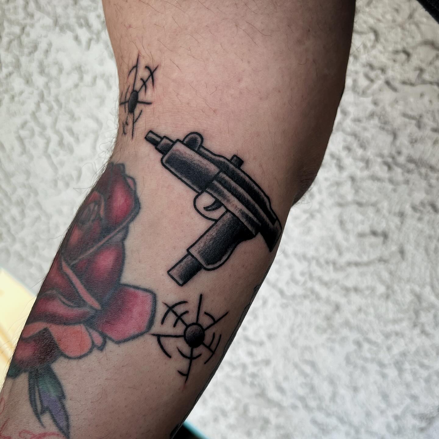 Gun and rose black and grey tattoo on the forearm by @sloanxkettering
