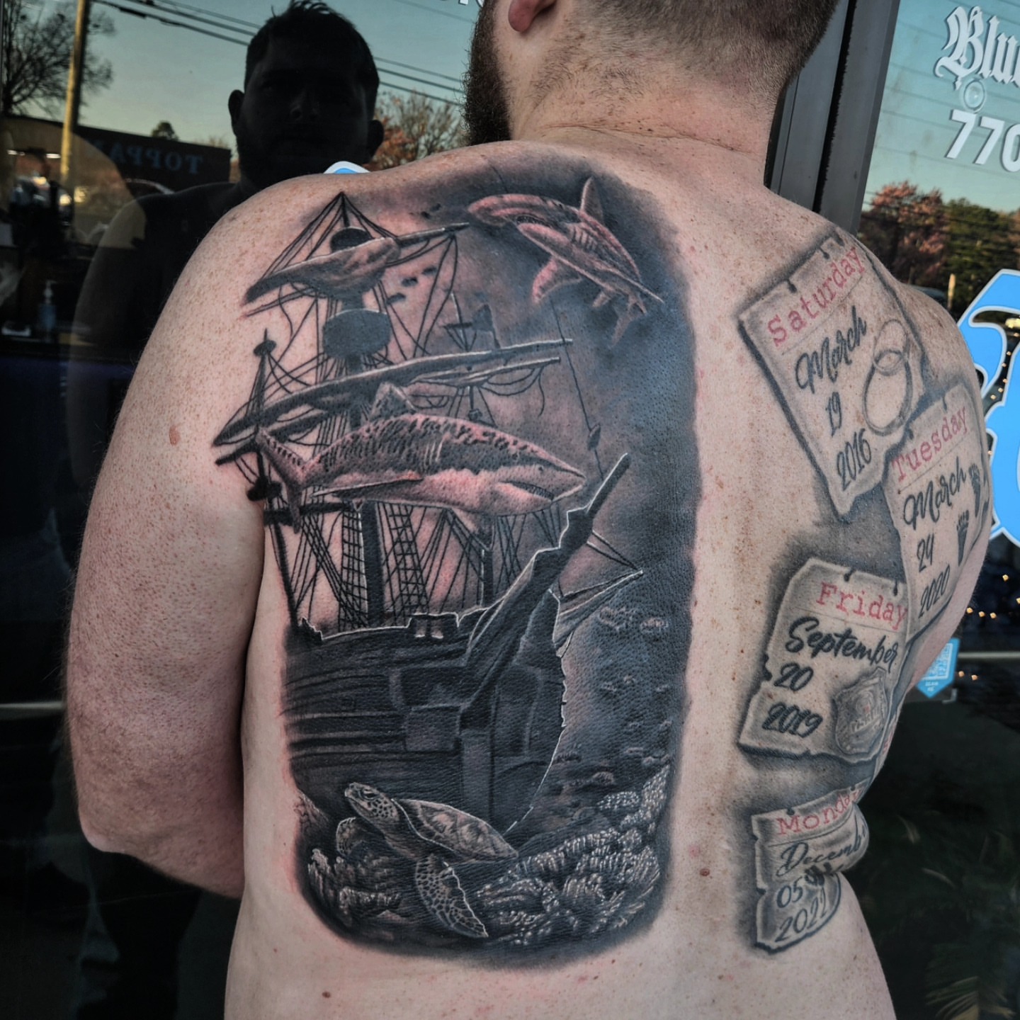 Ship and shark realism tattoo on the back by Mike Bugenhagen