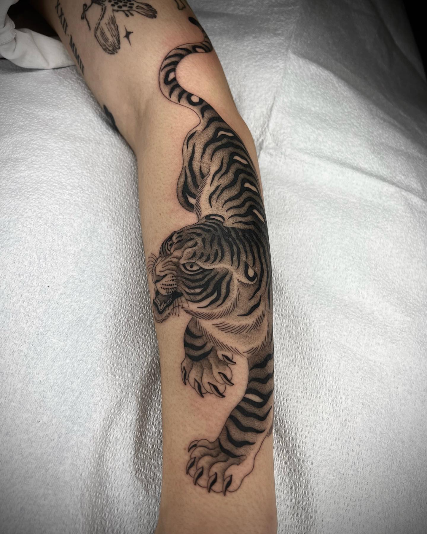 Tiger realism tattoo on the forearm by linahsiaotattoo