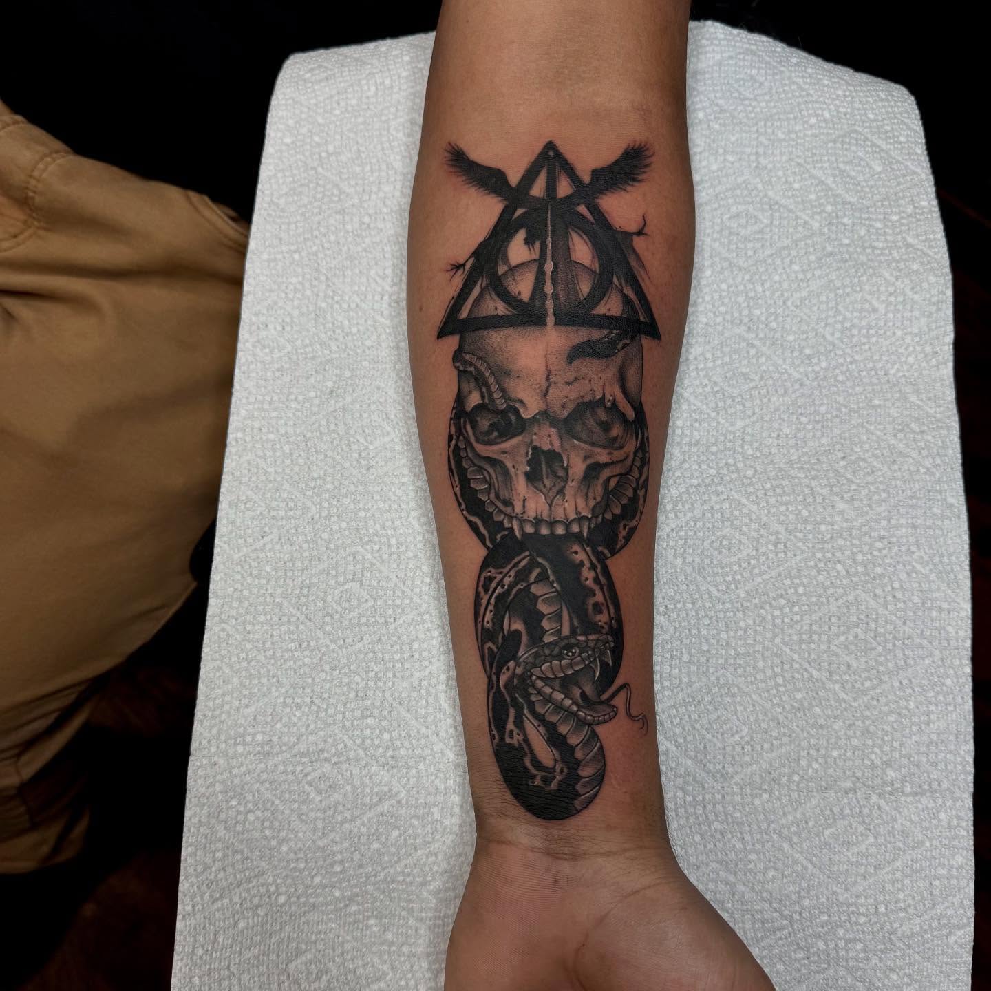 Skull and snake realism tattoo on the forearm by Lady.SINatra
