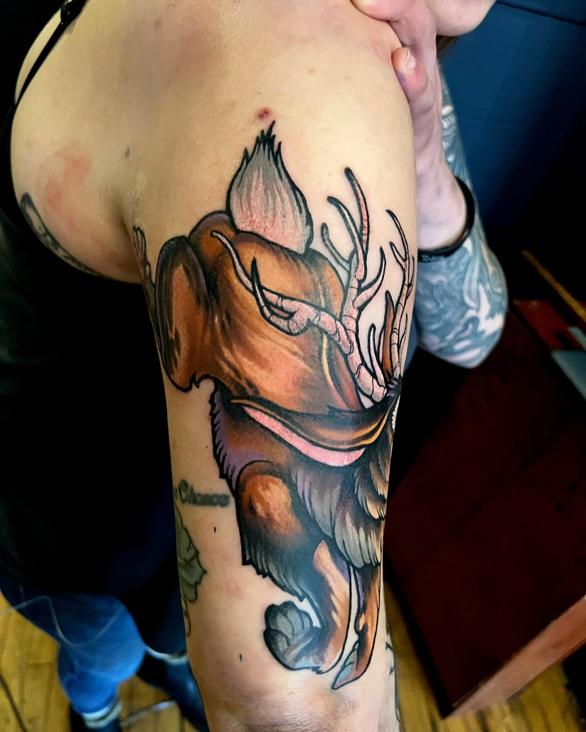 Stag head realism tattoo on the upper arm by Kevin Starai