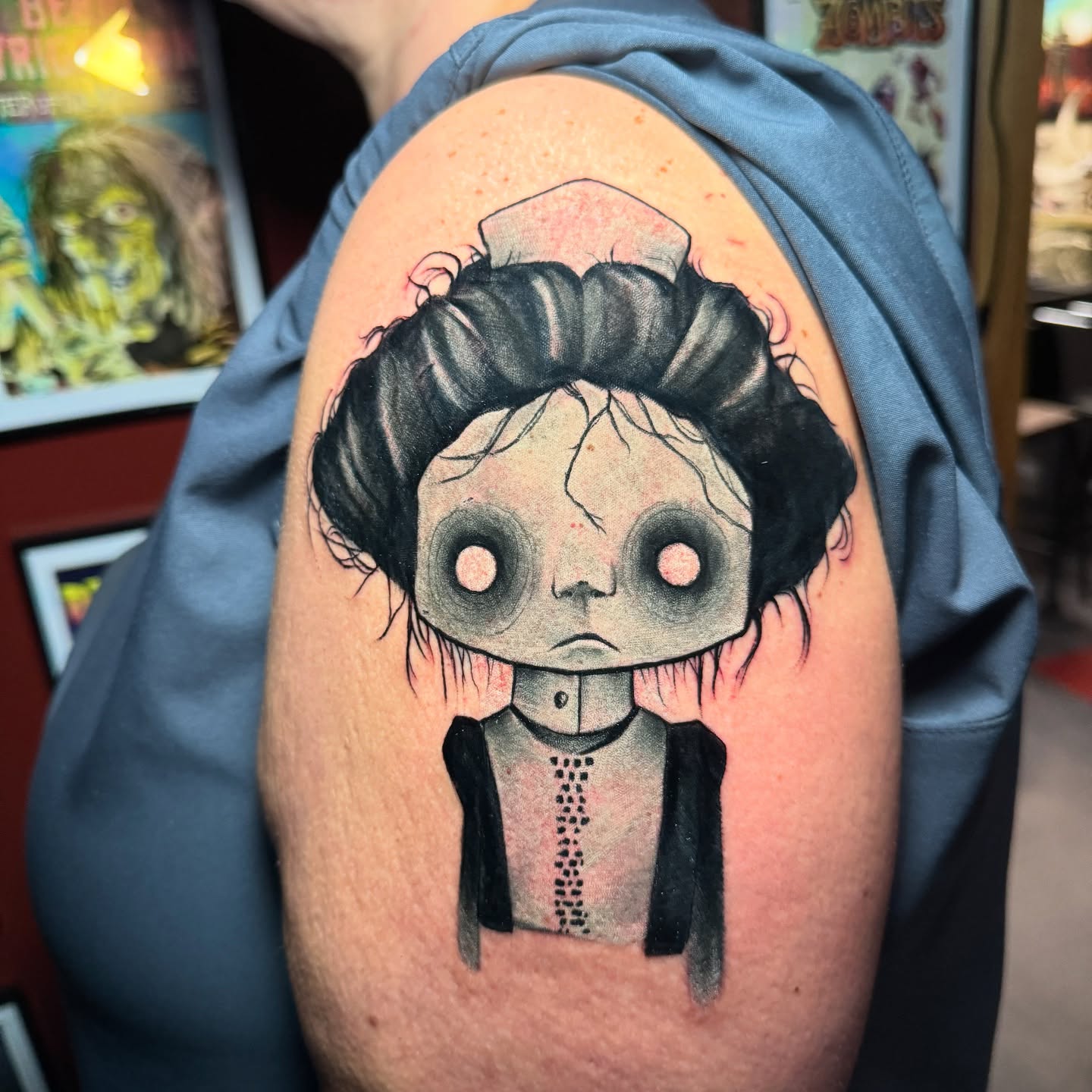 Doll dark realism tattoo on the shoulder by Garrett Rautio