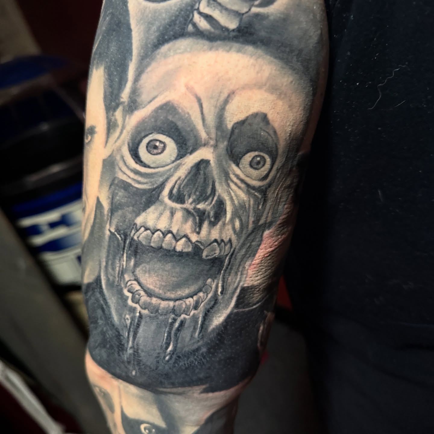 Grinning skull realism tattoo on the forearm by Garrett Rautio