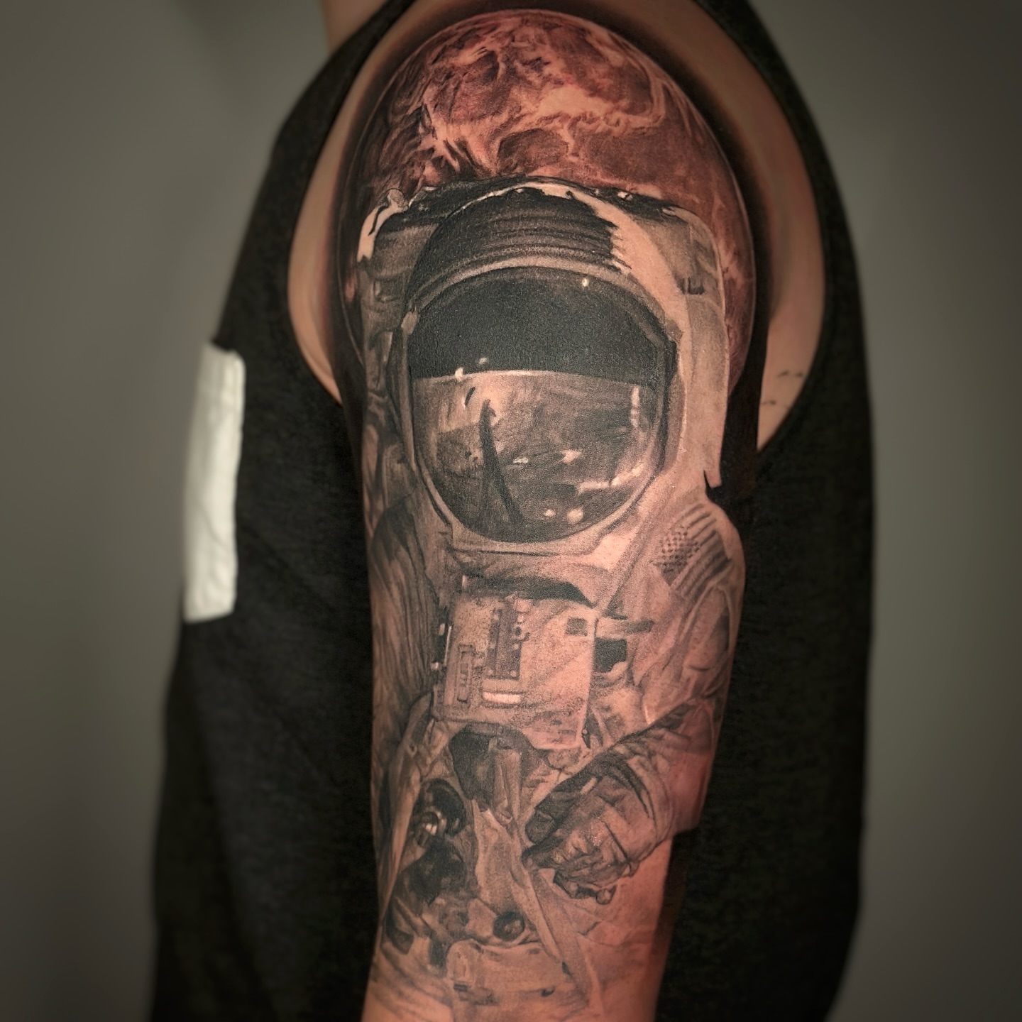 Astronaut realism tattoo on the forearm by Paige Jean