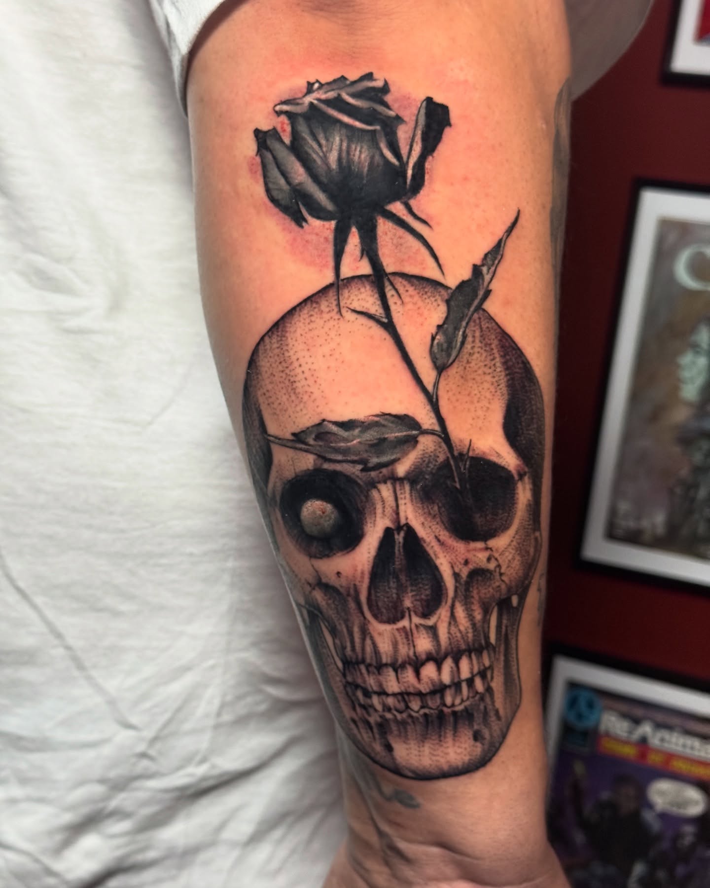 Skull with rose realism tattoo on the forearm by Garrett Rautio