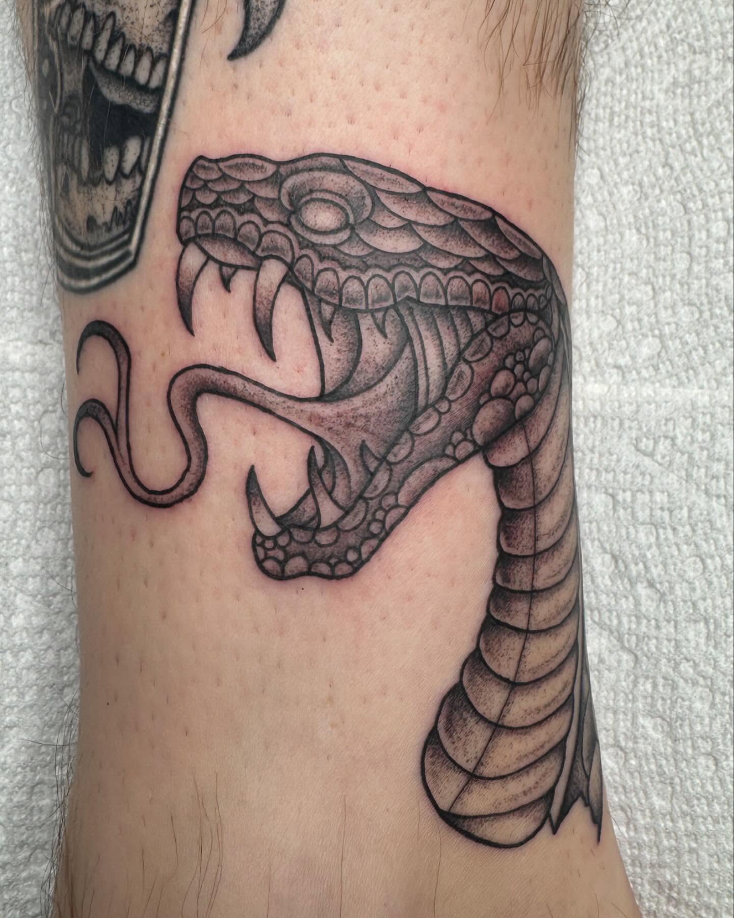 Snake black and grey tattoo on the forearm by Cory Perry-Servellon