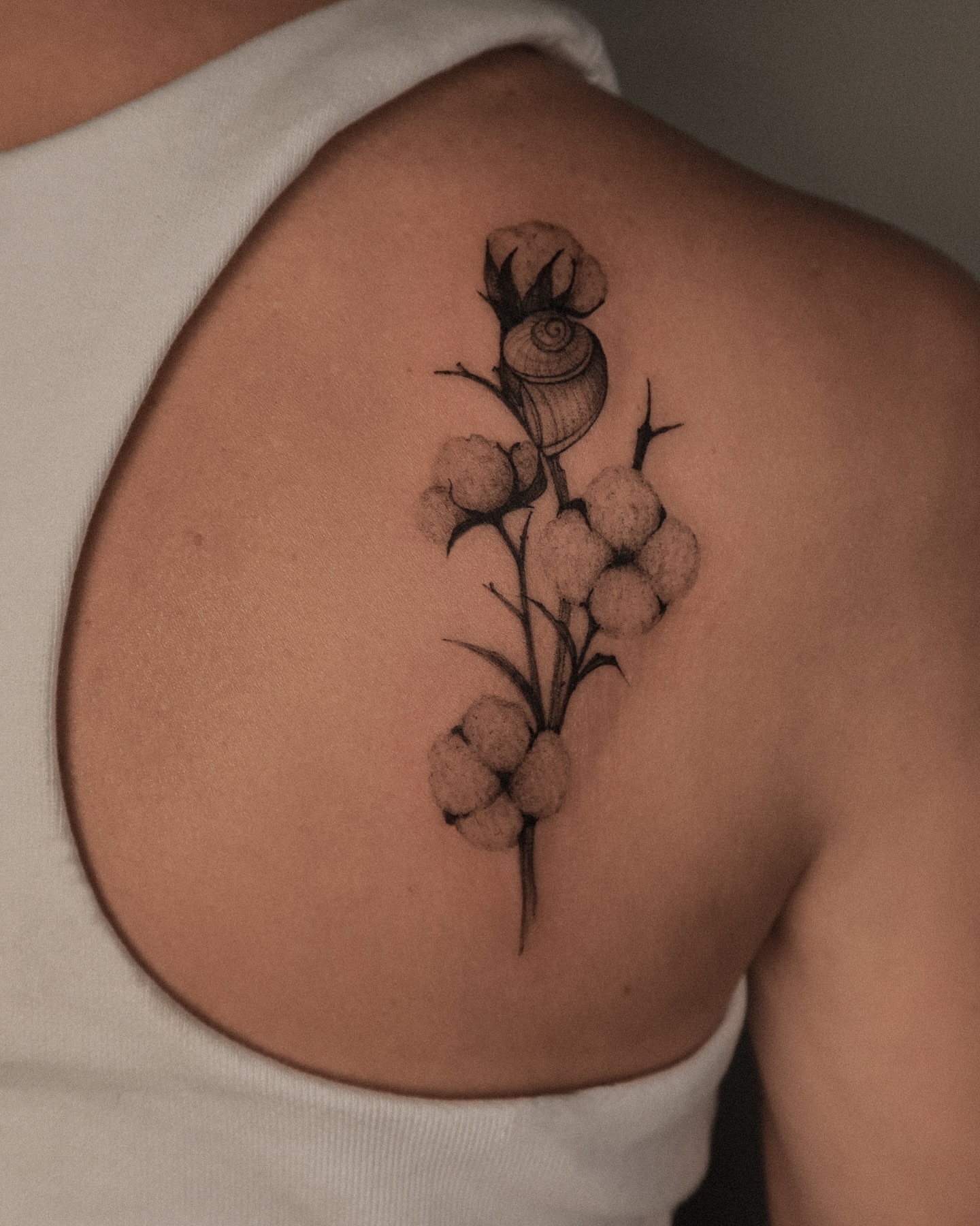Cotton plant black and grey tattoo on the back by Maria