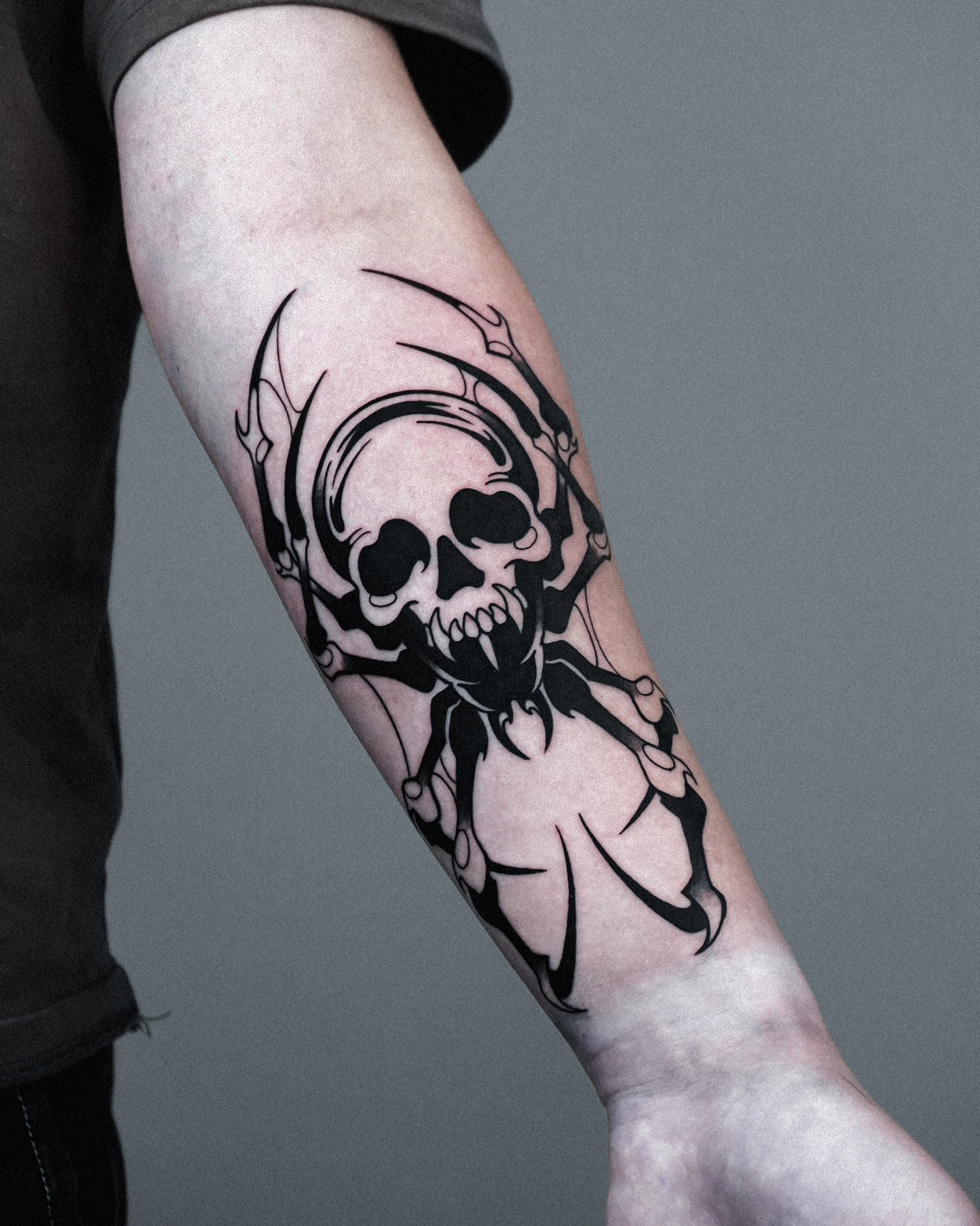 Skull and wings black and grey tattoo on the forearm by Jeremy "Jerms" Camposanto