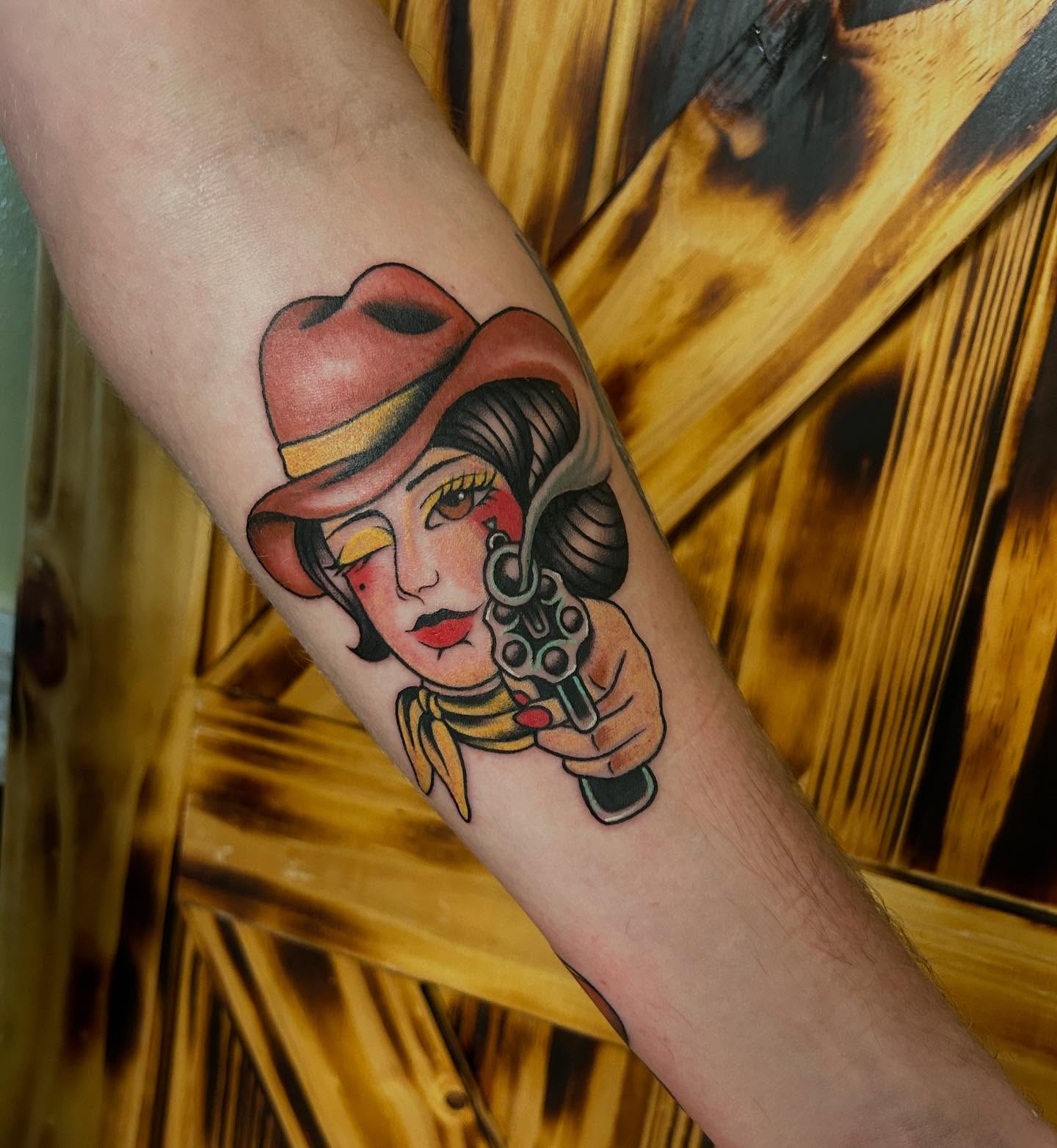 Cowgirl with revolver American traditional tattoo on the forearm by ππππππ ππππππ