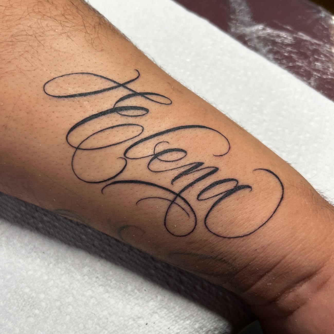 Script lettering lettering script tattoo on the forearm by Nick Ochoa