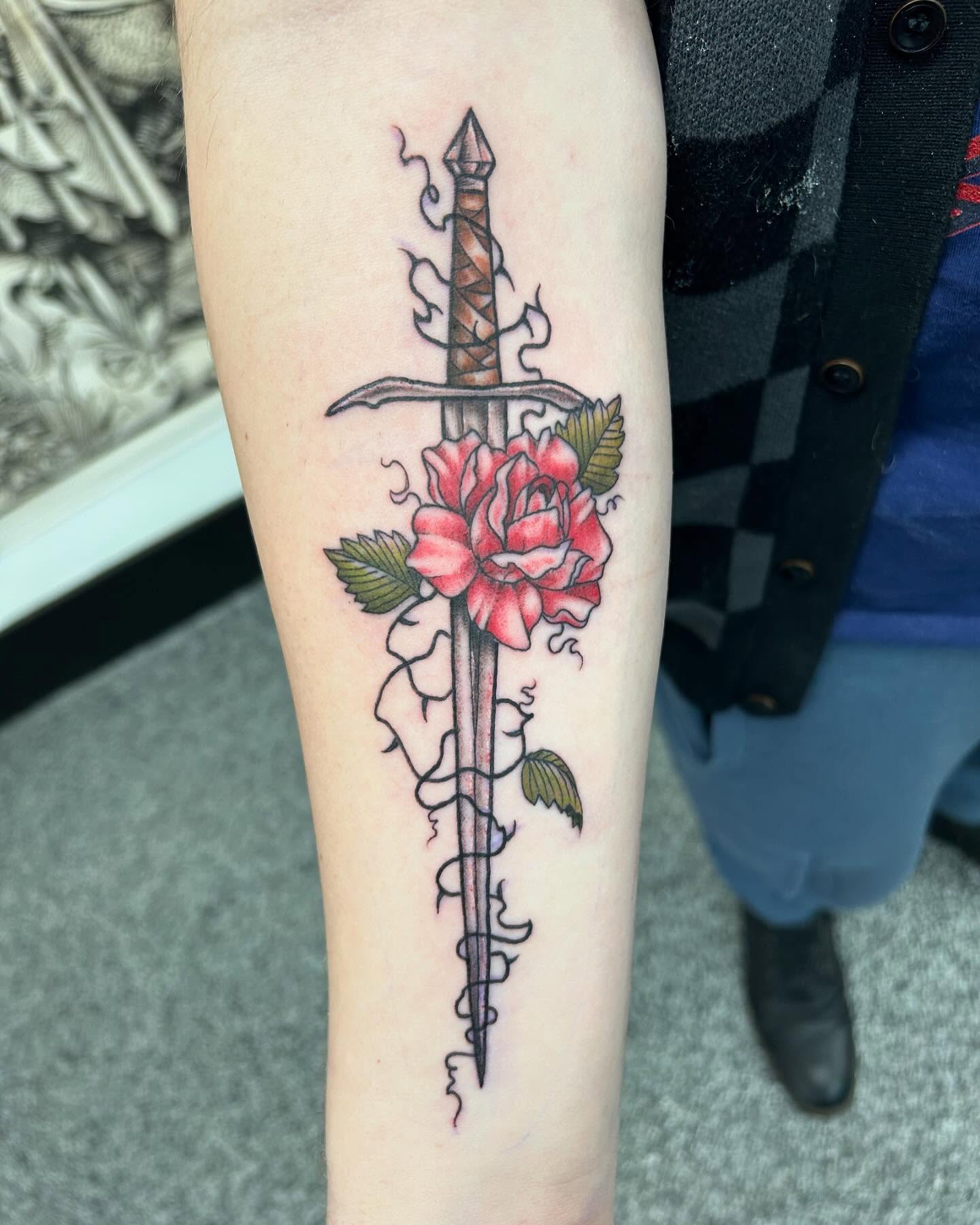Sword and rose neo-traditional tattoo on the forearm by Jayda Shell