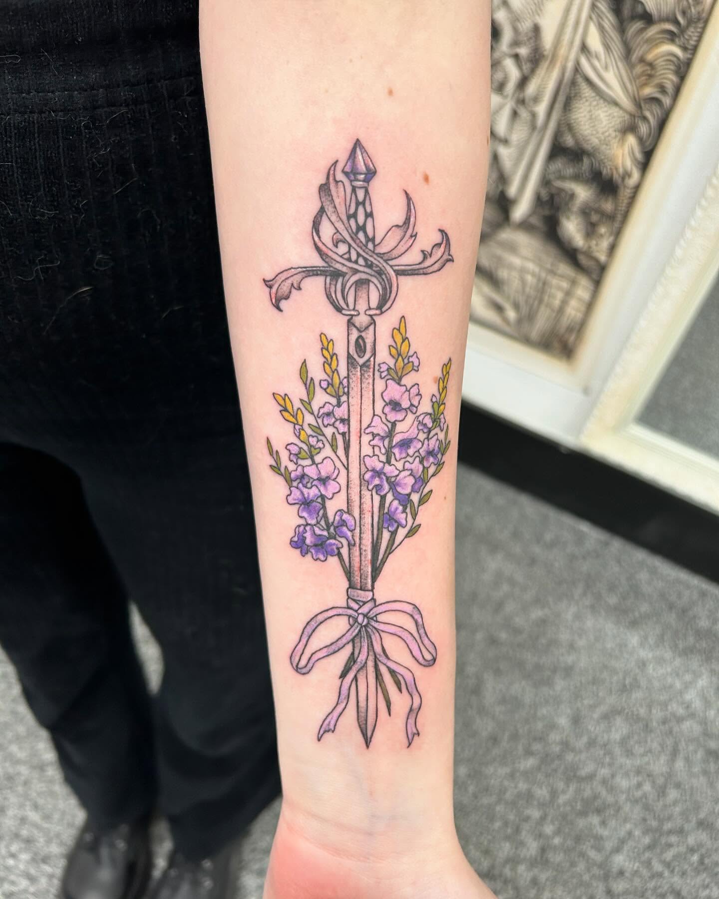 Sword and flowers new school tattoo on the forearm by Jayda Shell